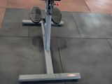 a gym area with a row of machines and other gym equipment