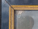 an old picture of a dog is reflected in a picture frame