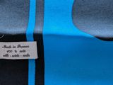 the label on the back of a blue and black shirt