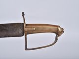 a gold and black sword with a black handle
