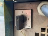a close up of a metal box with a blue handle