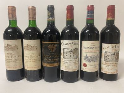 six bottles of wine are lined up on a white surface