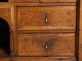 a wooden cabinet with drawers and a mirror on it