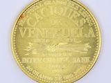 a gold coin with a picture of a boat on it