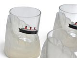 two glasses with a boat in them sitting on a table