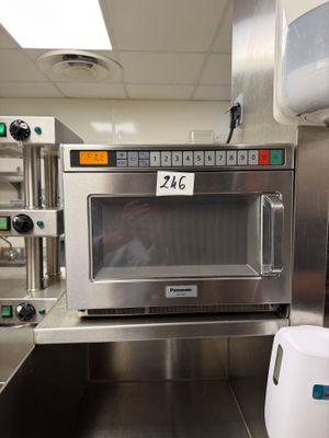 a microwave that is sitting in the middle of a kitchen