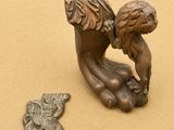 a small bronze statue of a woman holding a baby