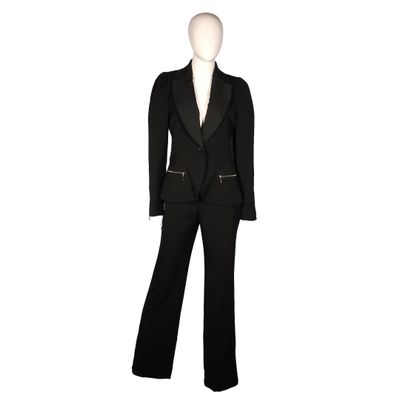 the woman is wearing a black suit and pants with a white shirt