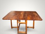 an old wooden table with two legs and a square top