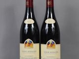 two bottles of wine sitting on top of a glass table