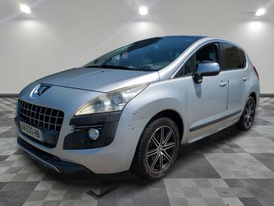 the small silver car is parked in a room with a checkered floor