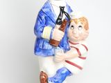 a figurine of a sailor holding a boy