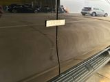 a sticker on the door of a car that is parked in a parking lot