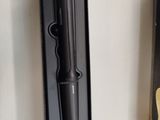 a black pen and a black box on a white wall