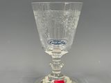 a clear glass with a red label on it