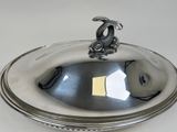 a silver plate with a bird on top of it