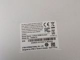 the back of a silver laptop with a sticker on it