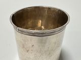 a silver cup that is sitting on a table