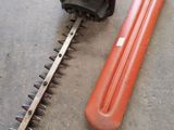 a picture of a hedger and a blower on the ground