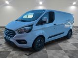 a white van is parked in a large room with a checkered floor
