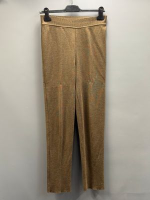 un pantalon marron suspendu à un cintre contre un mur