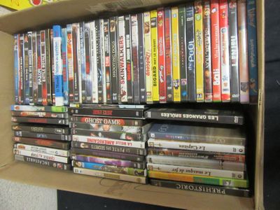 a lot of dvd ' s on a shelf in a box
