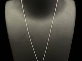 a necklace with an emerald and white topaz stone pendant