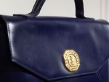 navy blue leather handbag with a gold buckle