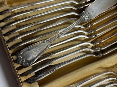 un lot de cuillères et fourchettes en argent dans une boîte