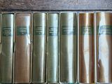 several old books are lined up on a wooden table