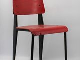 a red chair with black legs on a white background