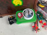 a green box with a fishing rod, reel, and other fishing equipment