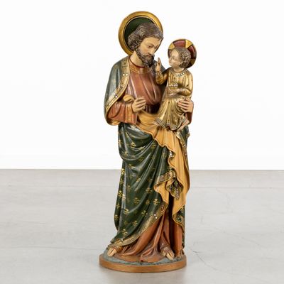 an image of a statue of jesus holding a child