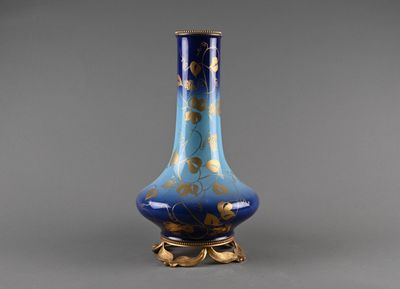 a blue and gold vase sitting on a table