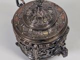 an antique silver plated box with a lid on a white surface