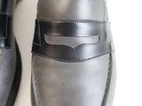 pair of men ' s black leather loafers on a white surface
