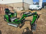 a picture of a tractor and a small excavator in a field