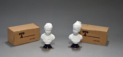 two figurines of a man and a woman are sitting next to a box