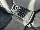 the interior of a car with a radio and dashboard controls