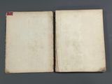 an open book sitting on top of a table next to a gray table