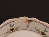 a white plate with a yellow and black design on it