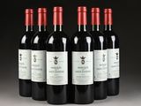 six bottles of red wine are lined up in a row