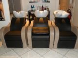four chairs in a salon with two sinks on each of them