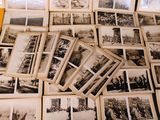 many old black and white photos on a table