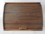 an old wooden roll top desk with a wooden handle