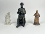 trois figurines représentant un homme et une femme assis l'un à côté de l'autre
