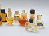 a lot of different bottles of perfume on a white surface