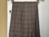 a close up of a pants hanging on a hanger on a door