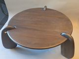 a small wooden table with a handle on it