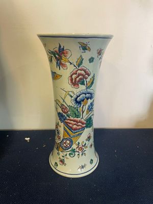 a vase that is sitting on a table with a blue table cloth